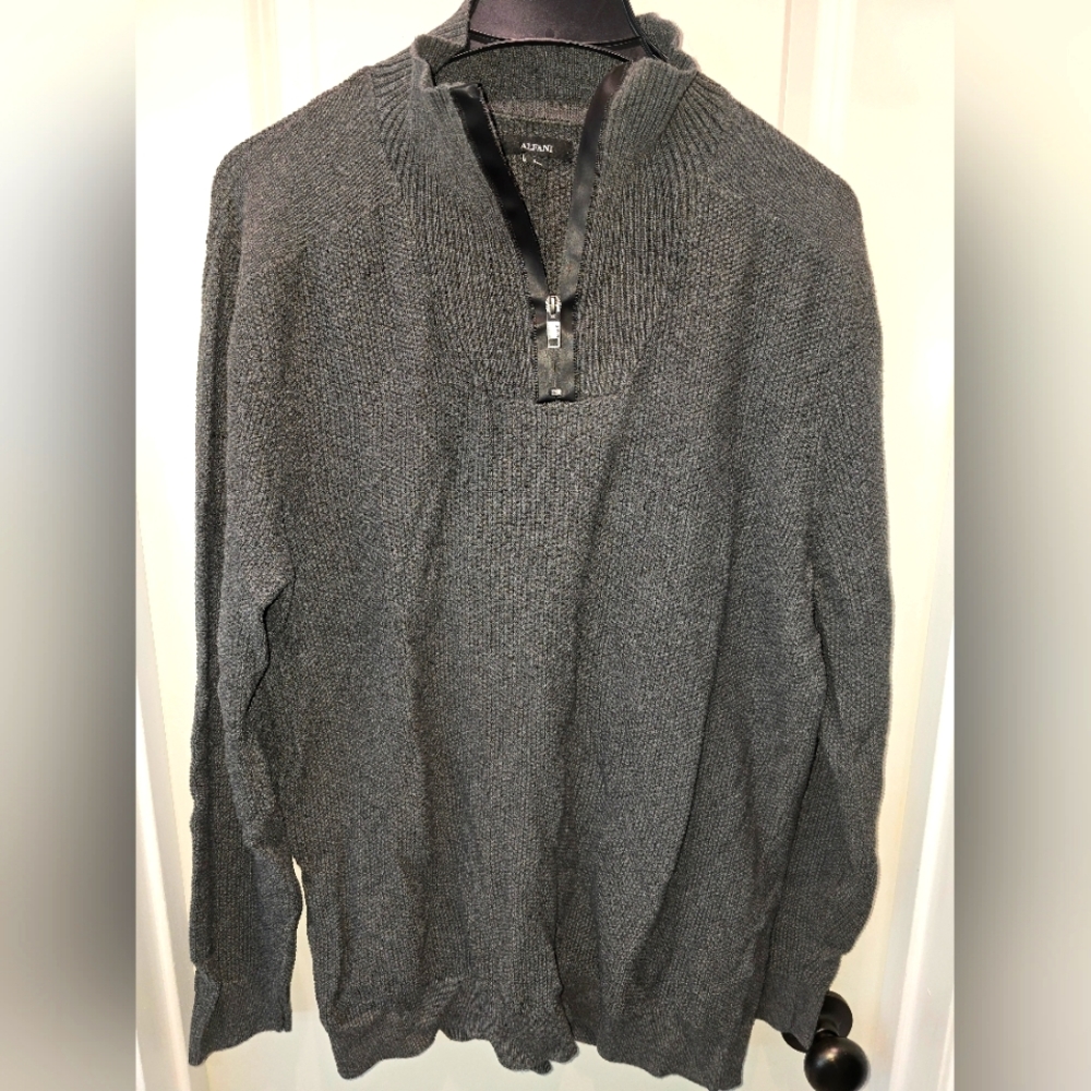 Grey sweater with faux leather accents around zipper